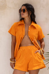 Vintage inspired terry towelling, elasticated shorts with side splits and 70s patch pockets.
