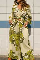 Elasticated wide leg pants in a bold large scale retro floral print in rich green and cream tones. Made in 100% rayon