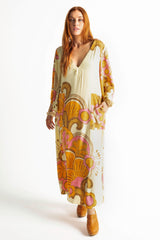 70s inspired maxi kaftan-style dress with bell sleeves , retro patch pockets and a v-neckline. Features a bold, large-scale tangerine, pink and brown retro geo print. Made in 100% cotton