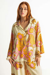 Bold retro floral print button up top in tangerine, pink and cream with 70s collar and bell sleeves. Made in 100% rayon