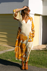 70s inspired maxi kaftan-style dress with bell sleeves , retro patch pockets and a v-neckline. Features a bold, large-scale  retro geo print. in rich mustard and brown tones. Made in 100% cotton