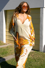 70s inspired maxi kaftan-style dress with bell sleeves , retro patch pockets and a v-neckline. Features a bold, large-scale  retro geo print. in rich mustard and brown tones. Made in 100% cotton