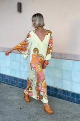 70s inspired maxi kaftan-style dress with bell sleeves , retro patch pockets and a v-neckline. Features a bold, large-scale tangerine, pink and brown retro geo print. Made in 100% cotton