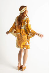 60s inspired mini smock dress with bell sleeves, patch pockets and a v-neckline. Features a bold, large-scale mustard and brown retro geo print. Made in 100% cotton