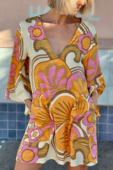 60s inspired mini smock dress with bell sleeves and a v-neckline. Features a bold, large-scale tangerine, pink and brown retro geo print. Made in 100% cotton