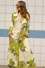 Button up top and wide leg pants set in a bold large scale retro floral print in rich green and cream tones. Made in 100% rayon