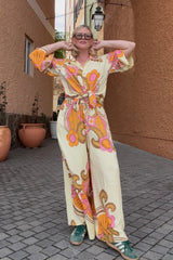 Bold retro floral print button up top in tangerine, pink and cream with 70s collar and bell sleeves, tied up worn with our One love palazzo pants. Made in 100% rayon