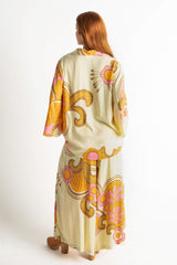 Back view. Bold retro floral print button up top in tangerine, pink and cream with 70s collar and bell sleeves. Made in 100% rayon