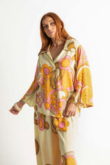 Bold retro floral print button up top in tangerine, pink and cream with 70s collar and bell sleeves. Made in 100% rayon