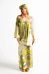 Bohemian style one shoulder maxi dress featuring a long, flowy frill that covers one arm and drapes elegantly down to the hips. This dress has side splits and showcases a large-scale bold, retro inspired print in rich green and cream tones. Made in 100% rayon.