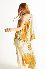 Bohemian style one shoulder maxi dress featuring a long, flowy frill that covers one arm and drapes elegantly down to the hips. This dress has side splits and showcases a large-scale bold, retro inspired print in rich mustard, brown and cream tones. Made in 100% rayon.