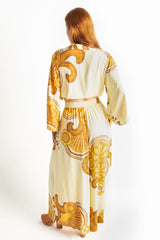 Back view. Elasticated wide leg pants with pockets in a bold large scale retro floral print in rich mustard and cream tones. Made in 100% rayon