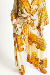 Elasticated wide leg pants with pockets in a bold large scale retro floral print in rich mustard and cream tones. Made in 100% rayon