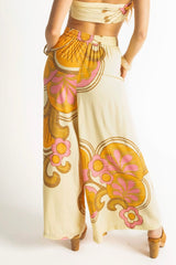 Elasticated wide leg pants in a bold large scale retro floral print in tangerine, pink, orange and cream tones. Made in 100% rayon