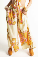 Elasticated wide leg pants in a bold large scale retro floral print in tangerine, pink, orange and cream tones. Made in 100% rayon