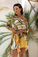 Large scale retro palm print flowy summer resortwear kaftan dress with round neckline batwing style 3/4 sleeves and drapes longer at the back 100% rayon black magenta and aqua colourway with colourful bangles to compliment