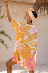 Large scale retro palm print flowy summer resort wear kaftan dress with round neckline batwing style 3/4 sleeves and drapes longer at the back 100% rayon flamingo pink colourway with matching head wrap and bamboo earrings to compliment