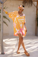 Large scale retro palm print flowy summer resort wear kaftan dress with round neckline batwing style 3/4 sleeves and drapes longer at the back 100% rayon flamingo pink colourway with matching head wrap and bamboo earrings to compliment