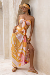 Large scale retro palm print sarong tied up around the waist flamingo pink colourway worn with our signiture wrap tied up 70s style as a boob tube  100% rayon bamboo hoop earrings visor and bangles to compliment