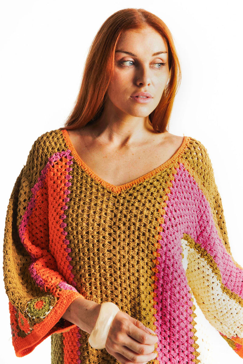 Boho style hand crocheted smock dress with 3/4 wide sleeves, featuring bold, pistachio, pink, orange and cream stripe sections and floral crochet details on the arms and hem. Made in 100% cotton