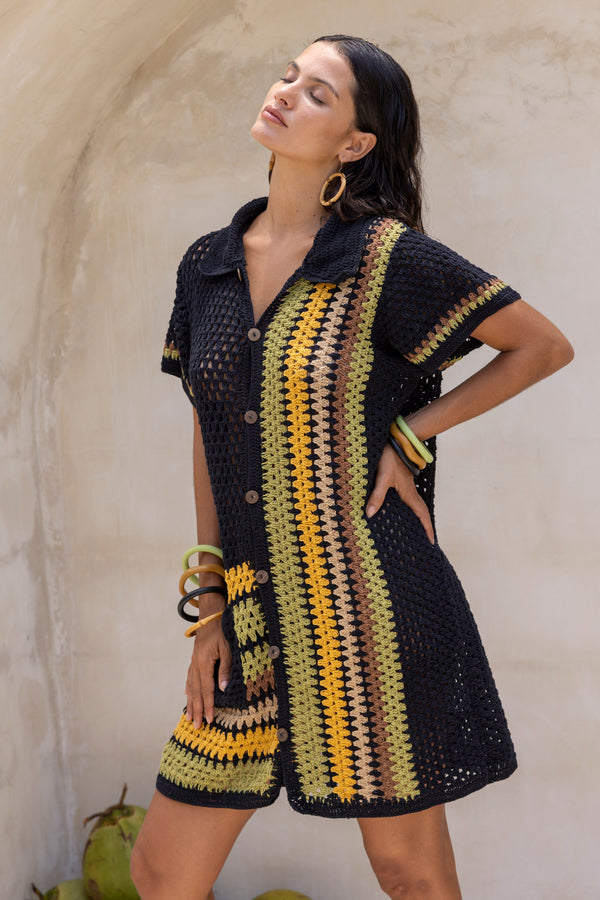 Hand crochet retro style button up shirt dress. Black colour base with 70s vintage stripes in olive, mustard, brown and beige. Vertical stripes on one side and horizonatal stripes on the other side. 70s style collar and coconut buttons brings retro chic vibes