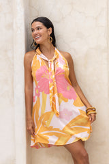 Large scale retro palm print flowy summer mini dress with v neckline that can also tie up to halter neck 100% rayon flaming pink colourway with bamboo earrings and bangles to compliment