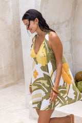 Large scale retro palm print flowy summer mini dress with v neckline that can also tie up to halter neck 100% rayon olive green colourway with bangles to compliment