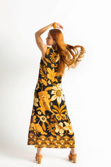 Bold floral vintage style maxi dress in a soft rayon voile with high bateau neckline and retro large scale brown and gold tone flowers on a black background