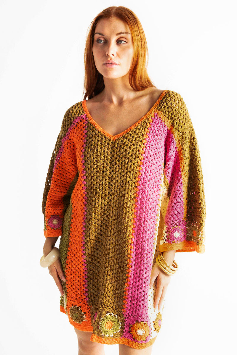 Boho style hand crocheted smock dress with 3/4 wide sleeves, featuring bold, pistachio, pink, orange and cream stripe sections and floral crochet details on the arms and hem. Made in 100% cotton