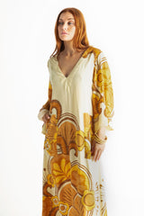 70s inspired maxi kaftan-style dress with bell sleeves , retro patch pockets and a v-neckline. Features a bold, large-scale  retro geo print. in rich mustard and brown tones. Made in 100% cotton