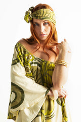 Versatile wrap that an be styled as a head wrap, scarf, wrap around top or belt to add that vintage-chic flair to any outfit. Made in 100% rayon in a green and cream, bold large scale retro print