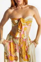 Versatile wrap that an be styled as a head wrap, scarf, wrap around top or belt to add that vintage-chic flair to any outfit. Made in 100% rayon in a pistachio, pink and mustard, bold large scale retro print