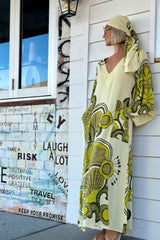 70s inspired maxi kaftan-style dress with bell sleeves , retro patch pockets and a v-neckline. Features a bold, large-scale  retro geo print. in rich green tones. Made in 100% cotton