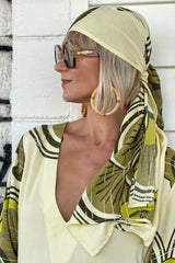 Versatile wrap that an be styled as a head wrap, scarf, wrap around top or belt to add that vintage-chic flair to any outfit. Made in 100% rayon in a green and cream, bold large scale retro print