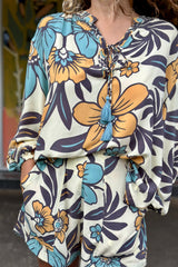 Vintage inspired high waist shorts with patch pockets  in a large scale floral print in blues and mustard with a cream  background