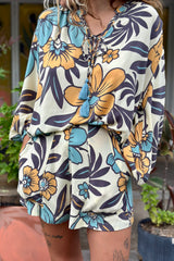 Vintage inspired high waist shorts with patch pockets  in a large scale floral print in blues and mustard with a cream  background