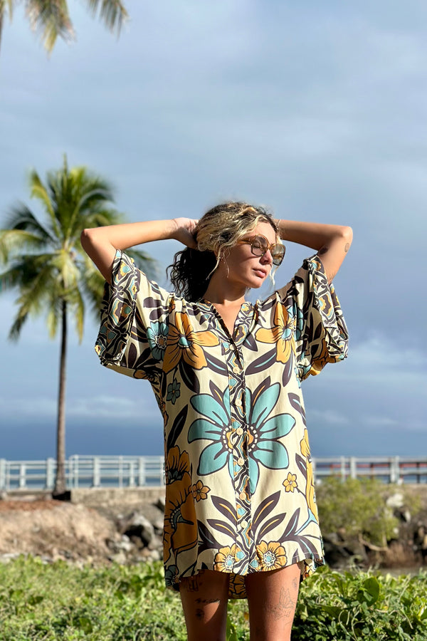 Vintage inspired bohemian style button up smock dress in a large scale floral print in blues and mustard with a cream  background