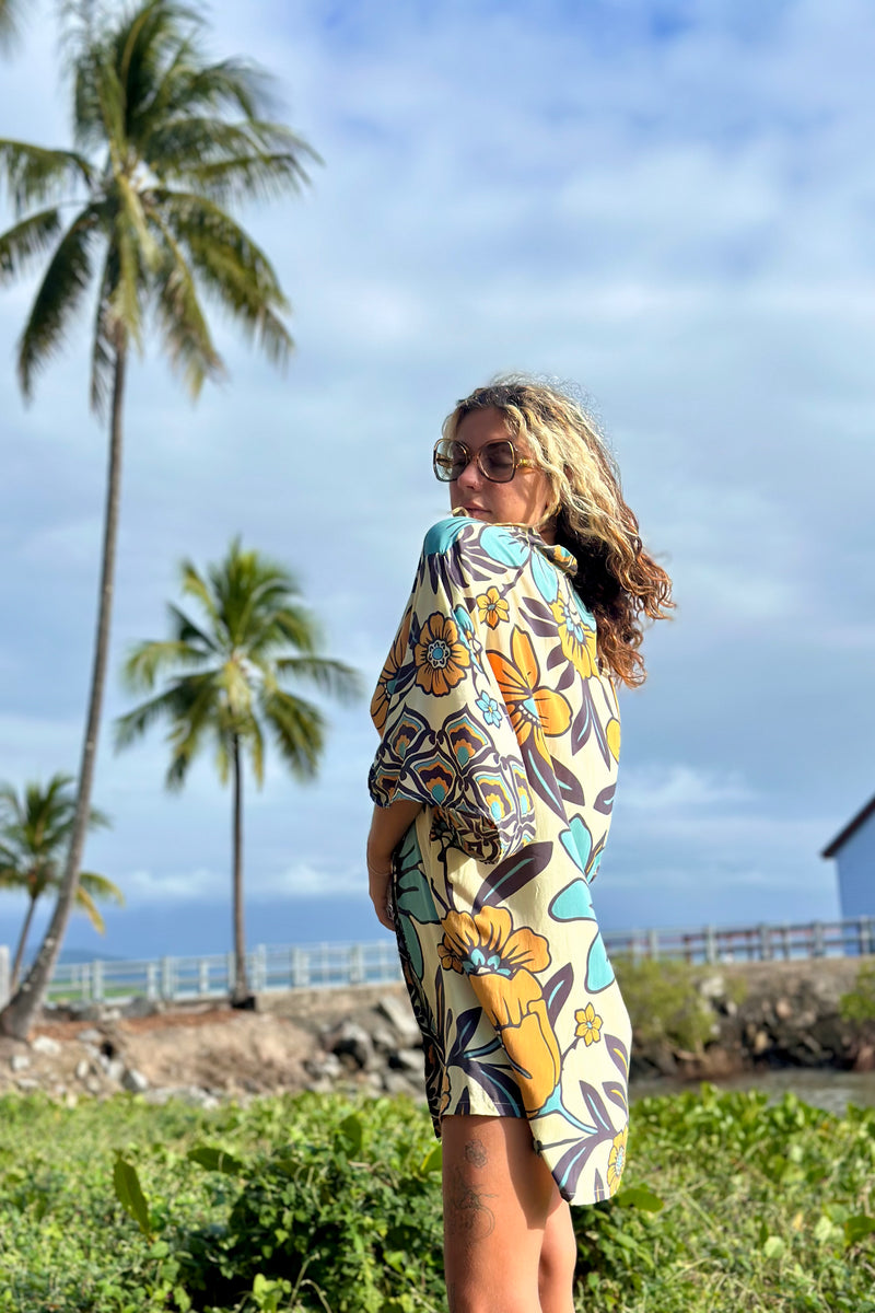 Vintage inspired bohemian style button up smock dress in a large scale floral print in blues and mustard with a cream  background