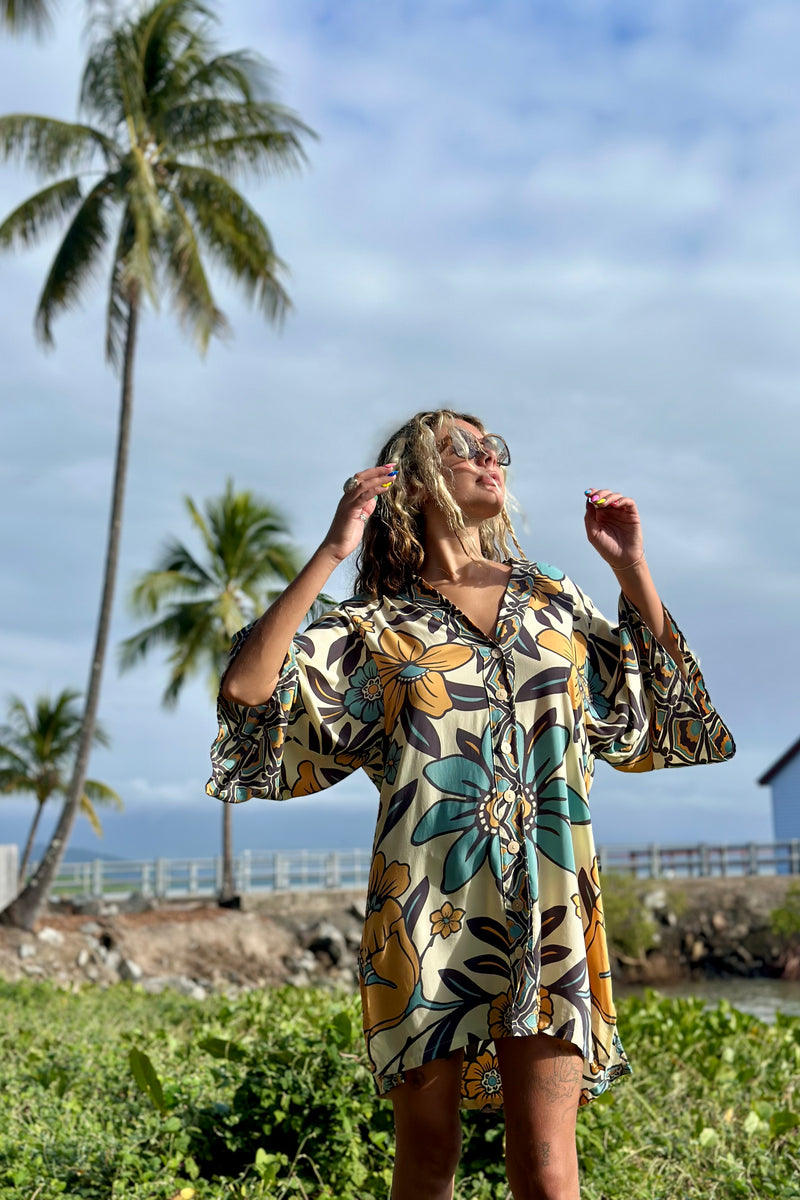 Vintage inspired bohemian style button up smock dress in a large scale floral print in blues and mustard with a cream  background