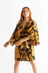 Vintage inspired bohemian style button up smock dress in a large scale floral print in brown and gold tones with a black background