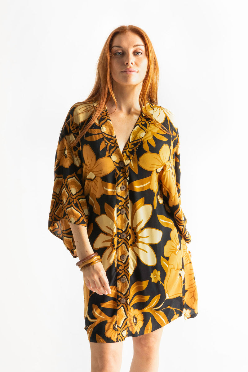 Vintage inspired bohemian style button up smock dress in a large scale floral print in brown and gold tones with a black background