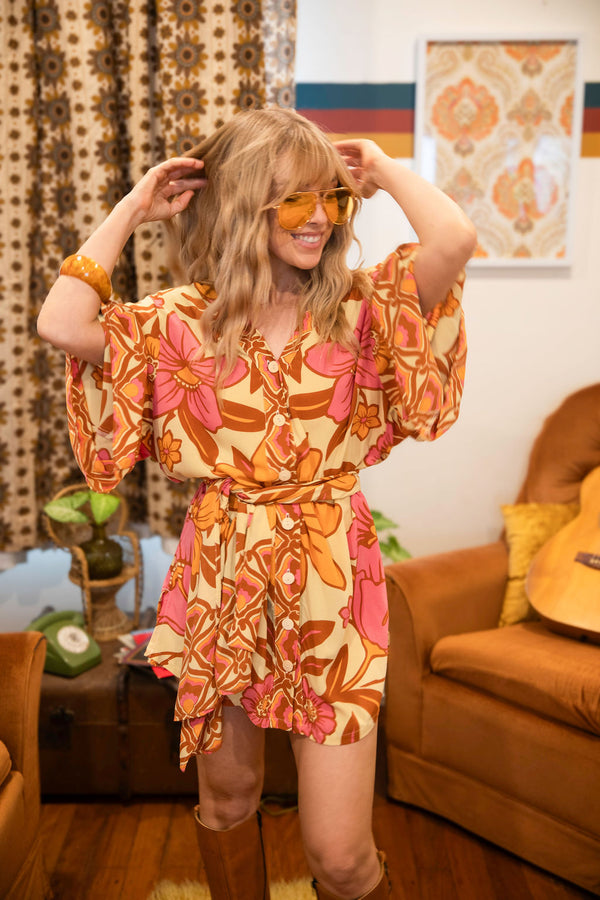 Vintage inspired bohemian style button up smock dress in a large scale floral print in pink and orange with a buttery cream  background