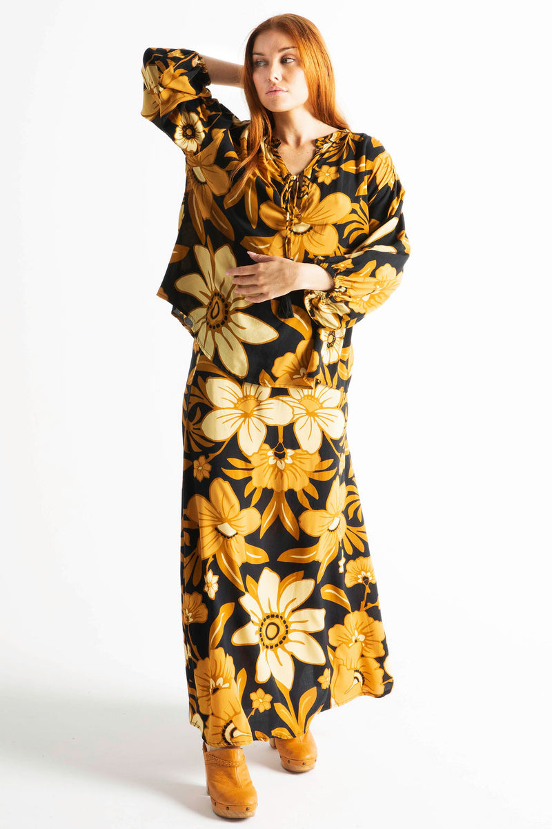 Vintage inspired A-line high waist maxi skirt in a large scale floral print in brown and gold tones with a black background