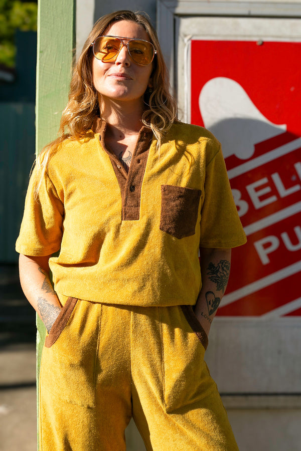 70s style retro terry towelling luxe tracksuit. Mustard with brown retro spliced stand-up collar and retro pocket details. Cotton medium weight terry fabric with 2% elastane