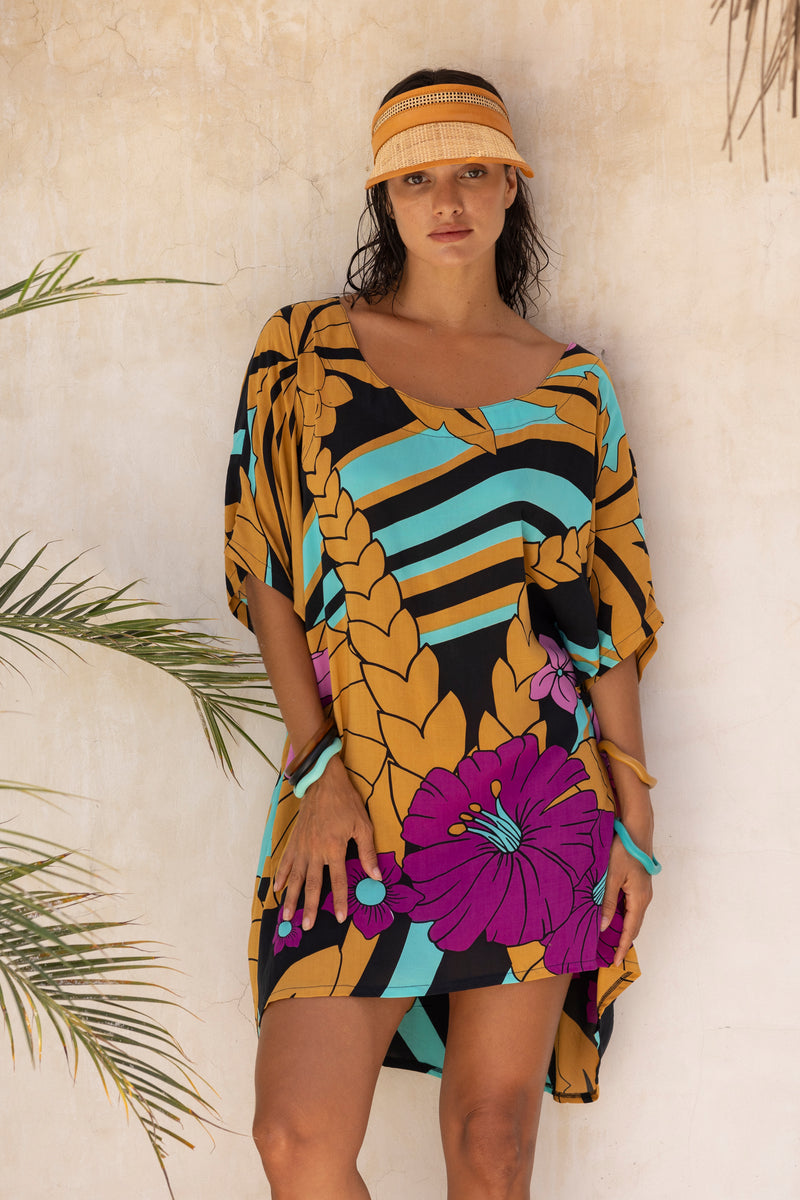 Large scale retro palm print flowy summer resortwear kaftan dress with round neckline batwing style 3/4 sleeves and drapes longer at the back  100% rayon black magenta and aqua colourway with colourful bangles to compliment