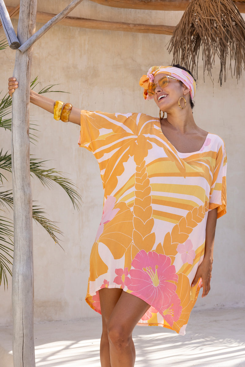 Large scale retro palm print flowy summer resort wear kaftan dress with round neckline batwing style 3/4 sleeves and drapes longer at the back  100% rayon  flamingo pink colourway with matching head wrap and bamboo earrings to compliment