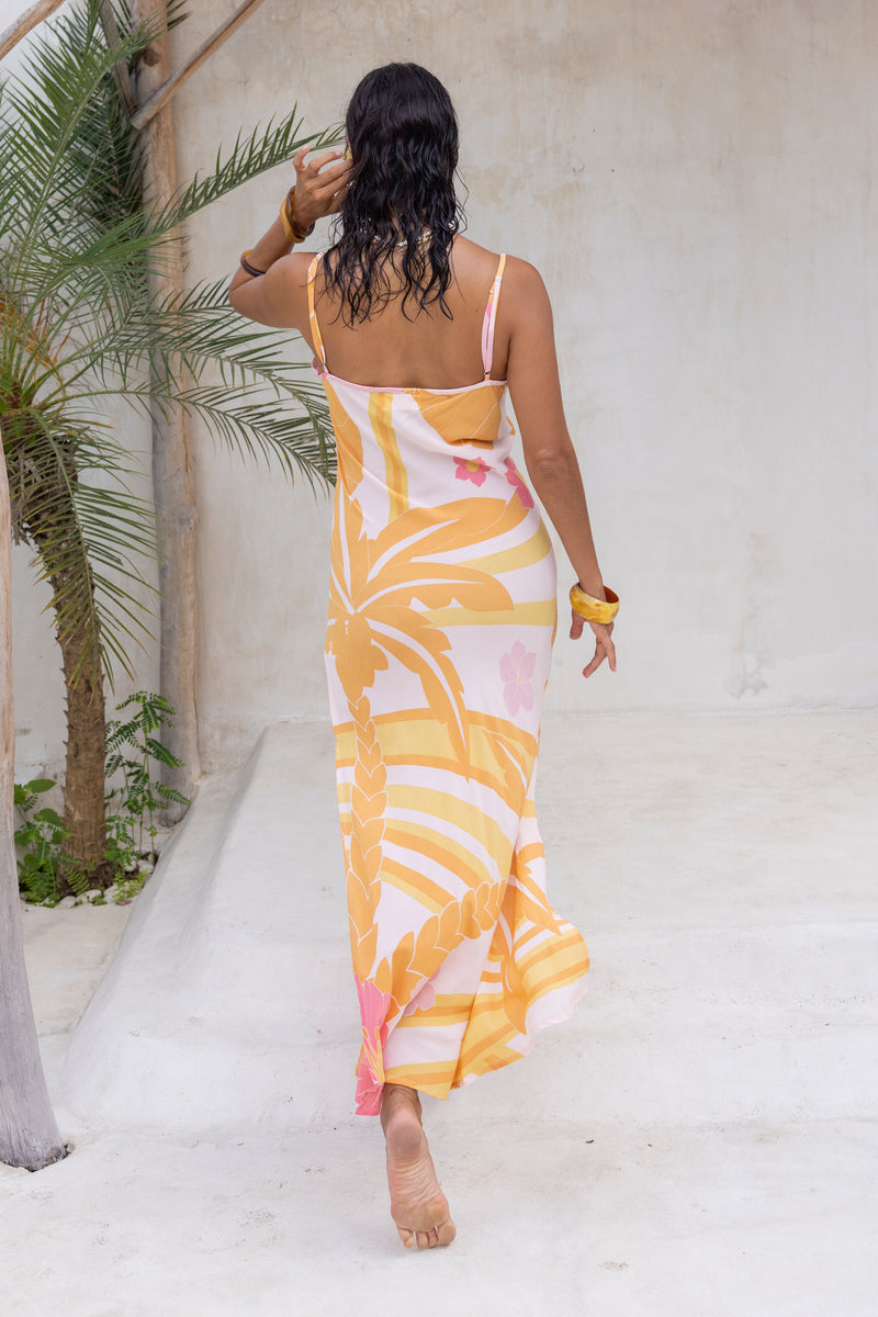 Large scale retro palm print flowy summer maxi bias slip dress with side splits  100% flamingo pink  colourway with chunky bangles to compliment