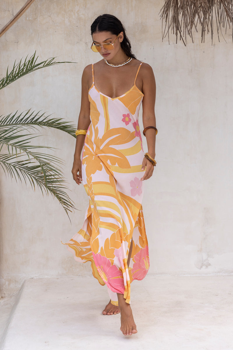 Large scale retro palm print flowy summer maxi bias slip dress with side splits  100% flamingo pink  colourway with chunky bangles to compliment