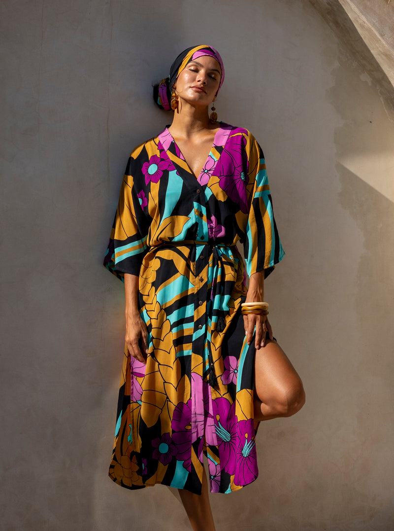 Large scale retro palm print button up robe  with side splits and tie 70s style batwing sleeves this midi length dress can worn as a kaftan with matching boho head wrap gives boho glam back aqua and magenta colourway 100% rayon