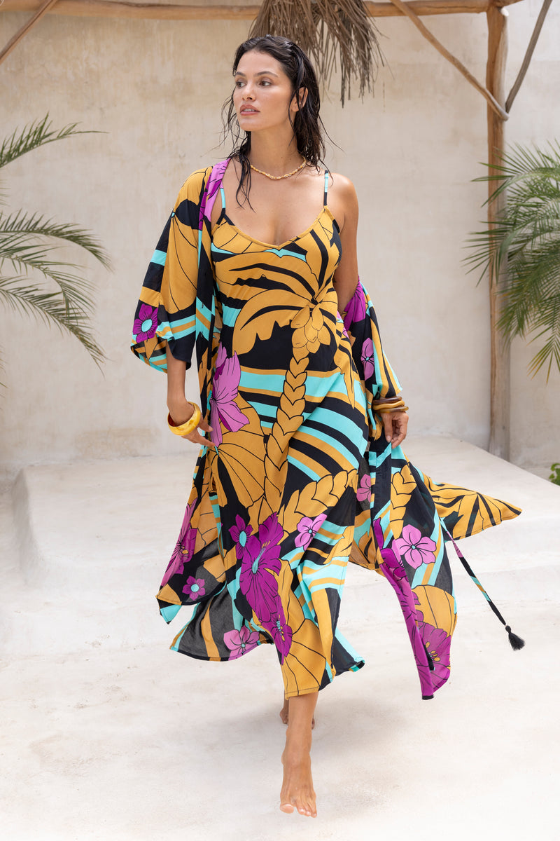 Large scale retro palm print flowy summer maxi bias slip dress with side splits  worn with matching Zsa Zsa robe 100% rayon  black magenta and aqua colourway with chunky bangles to compliment